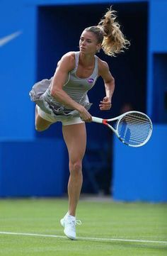 a female tennis player in action on the court