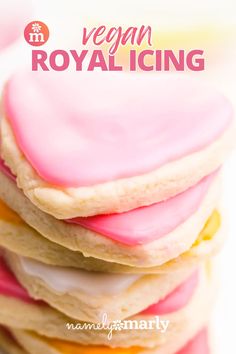 a stack of vegan royal icing cookies with pink and yellow frosting on top