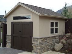 a small house with a brown garage door