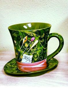 a green coffee cup and saucer on a table