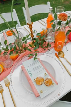 the table is set with oranges and silverware for an elegant dinner or brunch