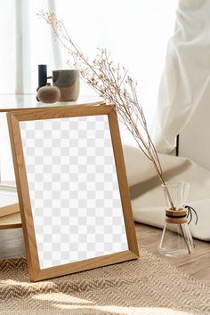 a wooden frame sitting on top of a table next to a vase