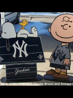 a cartoon character is standing in front of a sign that says new york yankees, charlie brown and snoopy