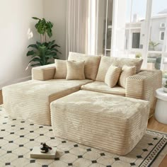 a living room with a large sectional couch and rug in front of a window overlooking the ocean