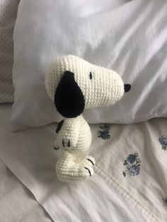 a crocheted dog sitting on top of a bed