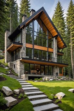 a modern house in the woods with stone steps leading up to it