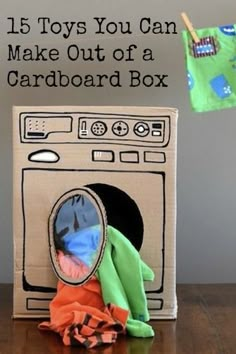 a stuffed animal is sitting in front of a cardboard box with an oven on it