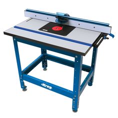 a table sawing machine sitting on top of a blue stand with a red object in the center