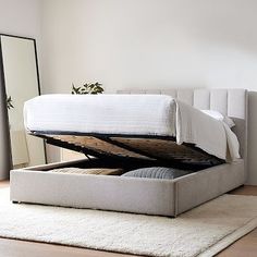 a bed with a mattress underneath it on top of a rug