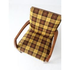 a brown and yellow checkered chair with wooden frame on the back, against a white background