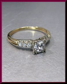 an engagement ring with three diamonds on it