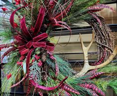 a christmas wreath with antlers and red ribbon