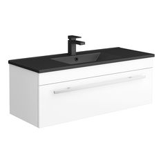 a white sink with black counter top and faucet