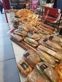 sandwiches and breads are on display in a store