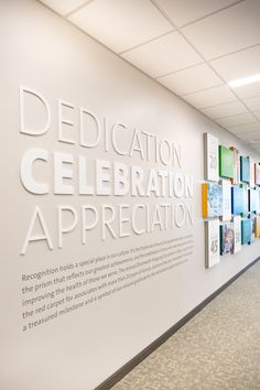 a large white sign on the side of a wall that says dedication celebration appreciation