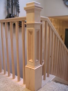 a wooden banister next to a stair case