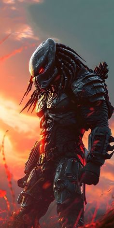 the predator character is standing in front of an orange sunset