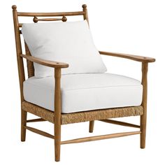 a wooden chair with white pillows on it