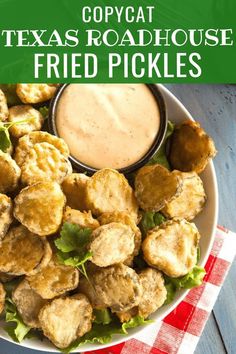 a white bowl filled with fried pickles next to a red and white checkered napkin