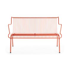 an orange metal bench sitting on top of a white floor