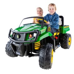 two children riding in a green and yellow toy vehicle with large tires on white background