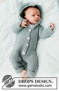 a baby laying on top of a bed wearing a crochet outfit