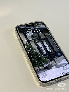 an iphone is sitting on a white surface