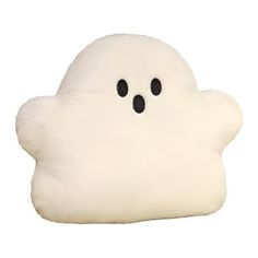 a white cloud pillow with two black eyes