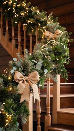 christmas garland on banisters with lights and greenery