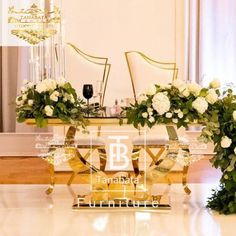 two vases filled with white flowers sitting on top of a marble floor in front of a mirror