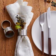 a place setting with silverware and napkins