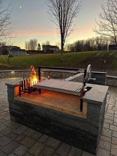 a fire pit sitting on top of a brick patio