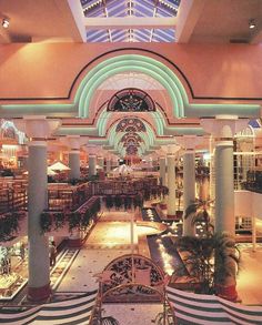 the inside of a shopping mall filled with lots of furniture and decorations, including benches