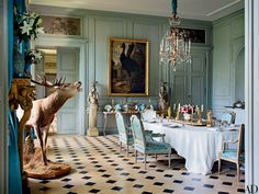 the dining room is decorated in blue and white with an animal statue on the table