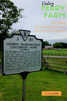 a sign in front of a wooden fence and grass with the words george washington's childhood home