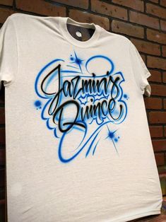 a white t - shirt with the words johnny's dance painted on it in blue ink