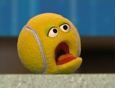 an angry tennis ball with its mouth open