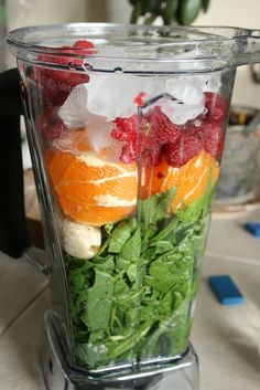 a blender filled with fruits and vegetables on top of a counter