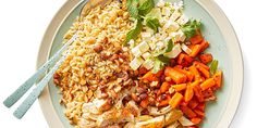 a white plate topped with rice, carrots and meat