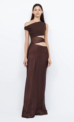 The Ophelia Maxi Dress is an elegant style crafted from a lustrous cocoa fabric featuring a soft mesh bust with an asymmetrical off-shoulder neckline and sheer waist cut outs. The dress is finished with a contrast skirt that falls into a maxi length. FIT: Designed to be fitted at the bust and waist. Maxi dress is accessed through invisible zip at side seam, strapless bra friendly. Fabric offers no stretch to the fit. SIZING: True to size, select your normal size. Model is 180cm / 5’11” wearing A Brown Dresses Formal, Elegant Outfit Classy, Australian Fashion Designers, Concept Clothing, Maxi Dress Formal, Glam Dresses, Brown Dress, Unique Dresses, Event Dresses