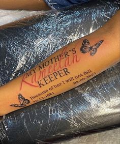 a woman with a tattoo on her arm that says, my mother's keeper