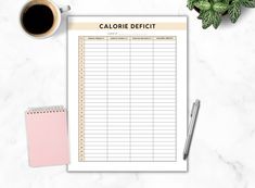 a calorie diet chart on a clipboard next to a cup of coffee