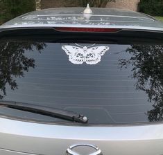 a car with a butterfly sticker on it's windshield