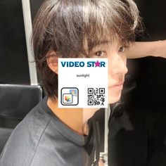 a young man getting his hair cut with a video star sticker attached to his head