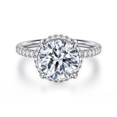 a round cut diamond ring with pave set shoulders