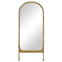 a tall mirror sitting on top of a wooden stand