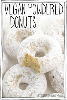 a pile of vegan powdered donuts with a bite taken out of one