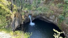 there is a small waterfall coming out of the cave