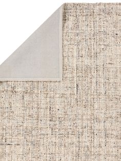 an area rug with a white and beige color scheme