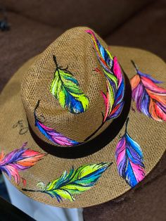 a hat with colorful feathers painted on it